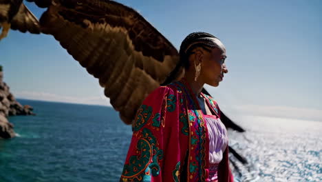 woman and eagle by the sea