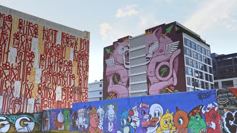 travel blog video captures the vibrant street art of wynwood walls, miami, showcasing large-scale murals painted on buildings.
