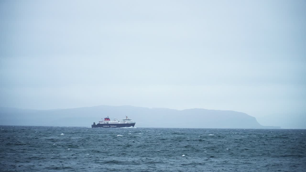 Ferry sailing on the ocean towards the mountains