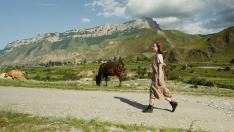 woman walking through scenic mountain valley