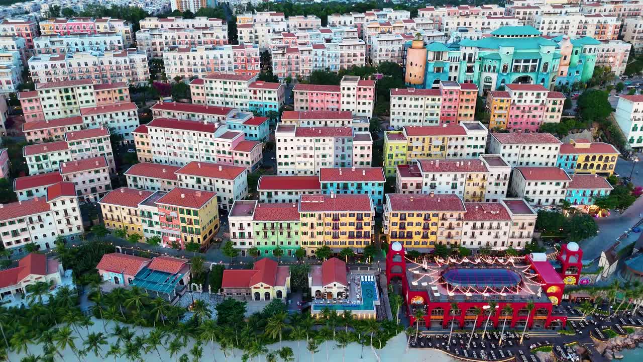 Zoom-out drone shot of Sunset Town panoramic view during sunset, a fake Italian city in Phu Quoc Island, Vietnam.