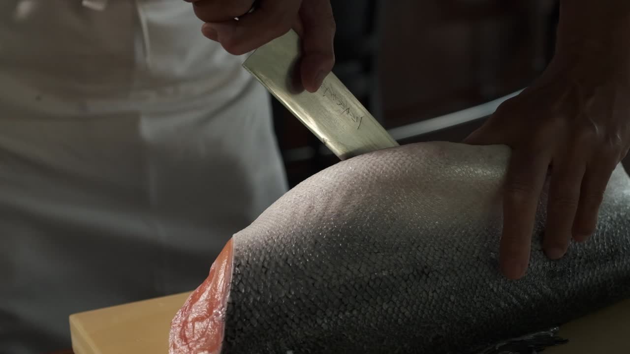 Chef preparing fresh salmon in the kitchen