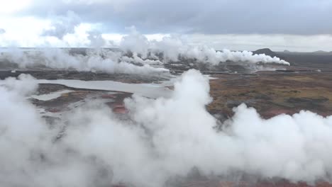 aerial shot flying through the steam of a geothermal power station