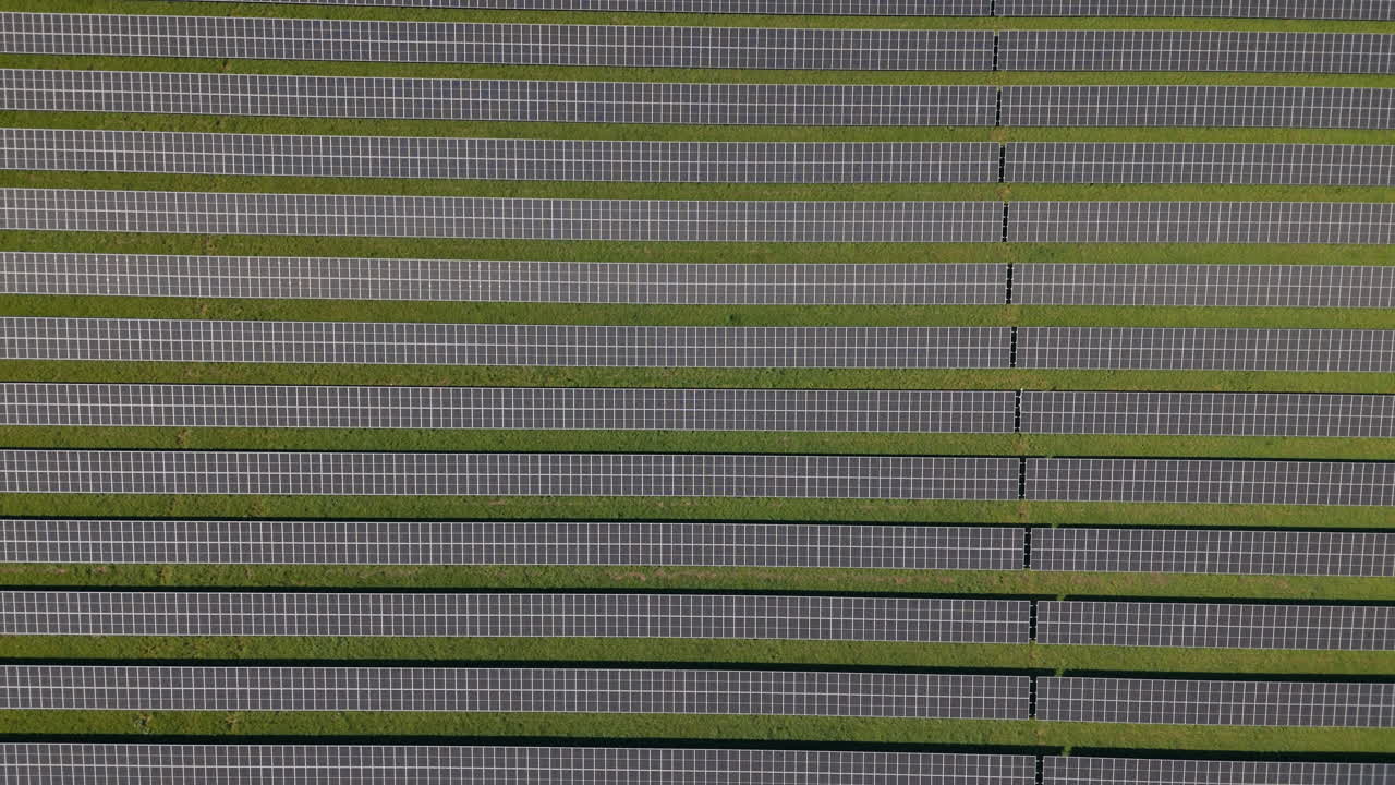독일의 초록색 언덕에 여러 태양 패널을 가진 거대한 태양광 발전소에 대한 공중 압박, 재생 가능한 에너지, 공중 영상