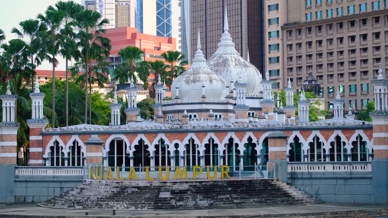 Scenic view of Sultan Abdul Samed Jamek mosque and Kuala Lumpur sign on Klang River and Gombak River in capital city of Kuala Lumpur, Malaysia