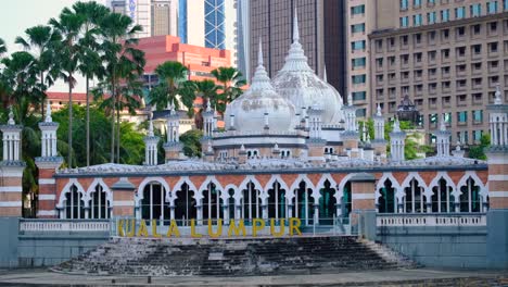 scenic view of sultan abdul samed jamek mosque and kuala lumpur sign on klang river and gombak river in capital city of kuala lumpur, malaysia