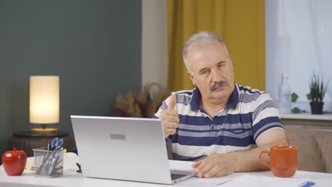 el anciano que trabaja en la oficina de casa asiente a la cámara.