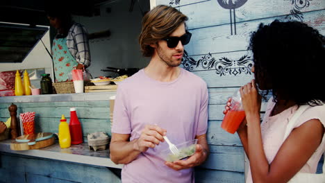 Couple-interacting-while-having-snacks-and-juice