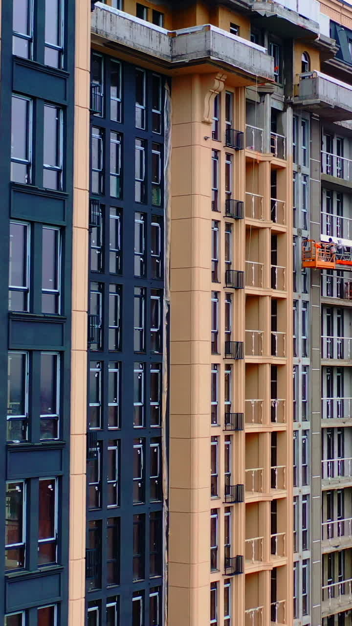 Residential apartment buildings under construction. Building of a modern multi storey apartment house. Real estate development. Vertical video
