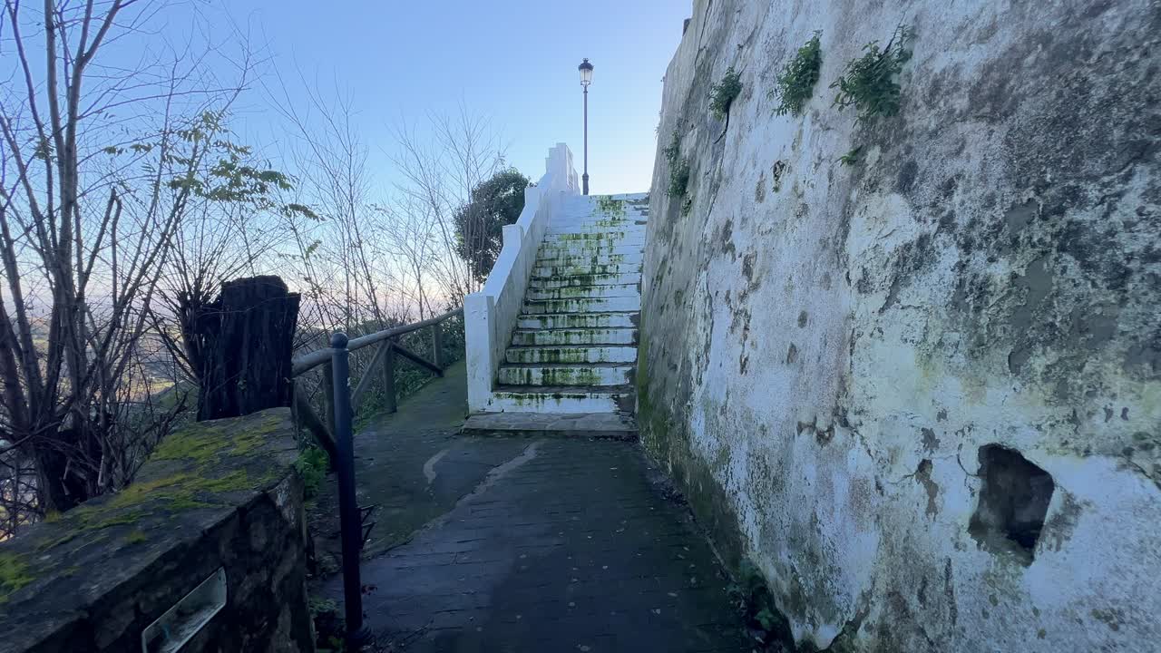 shot moving through a narrow stone passageway located near the outskirts of a city
