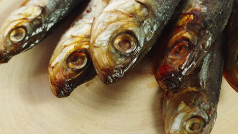 smoked sardines on wooden board