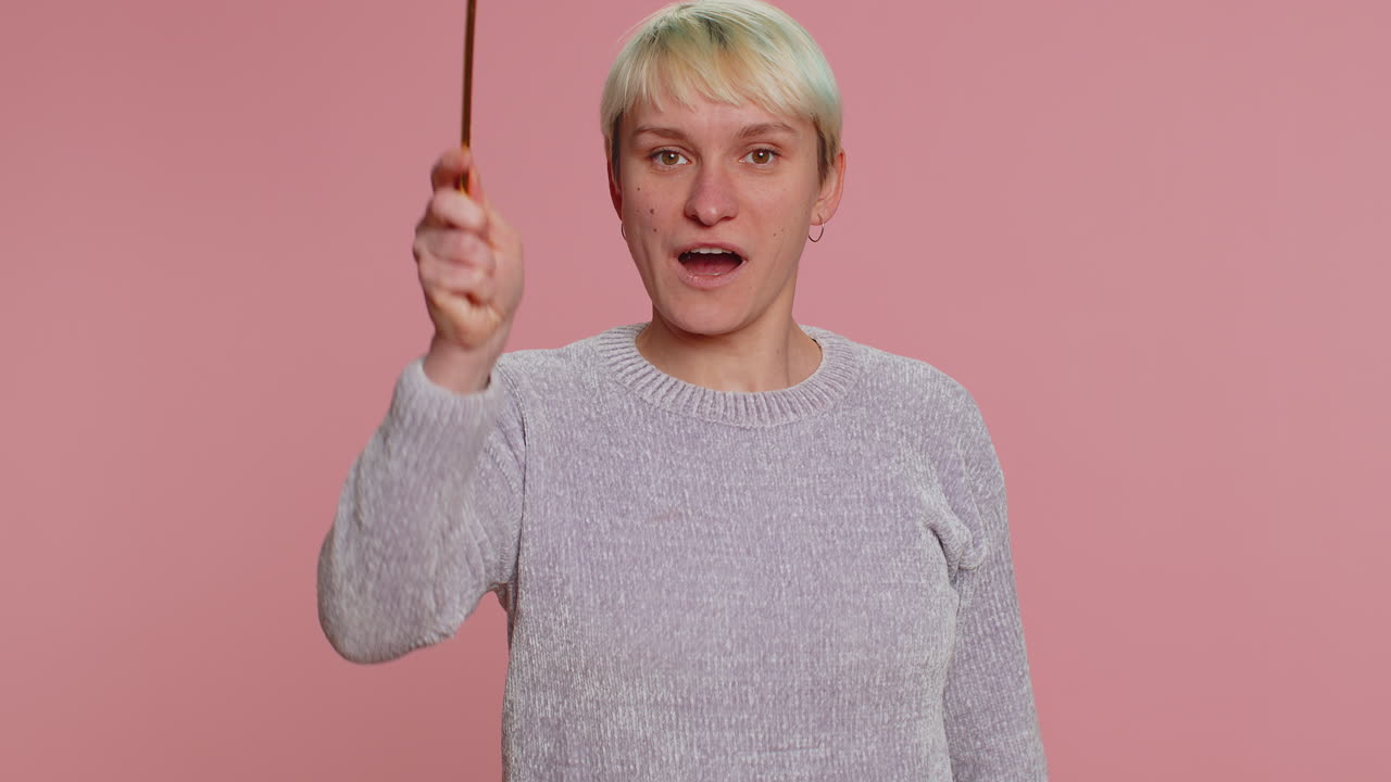 Woman with a magic wand smiling at the camera