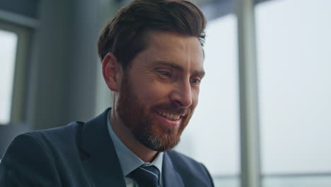 closeup happy man working papers at cityscape office. man reading documents