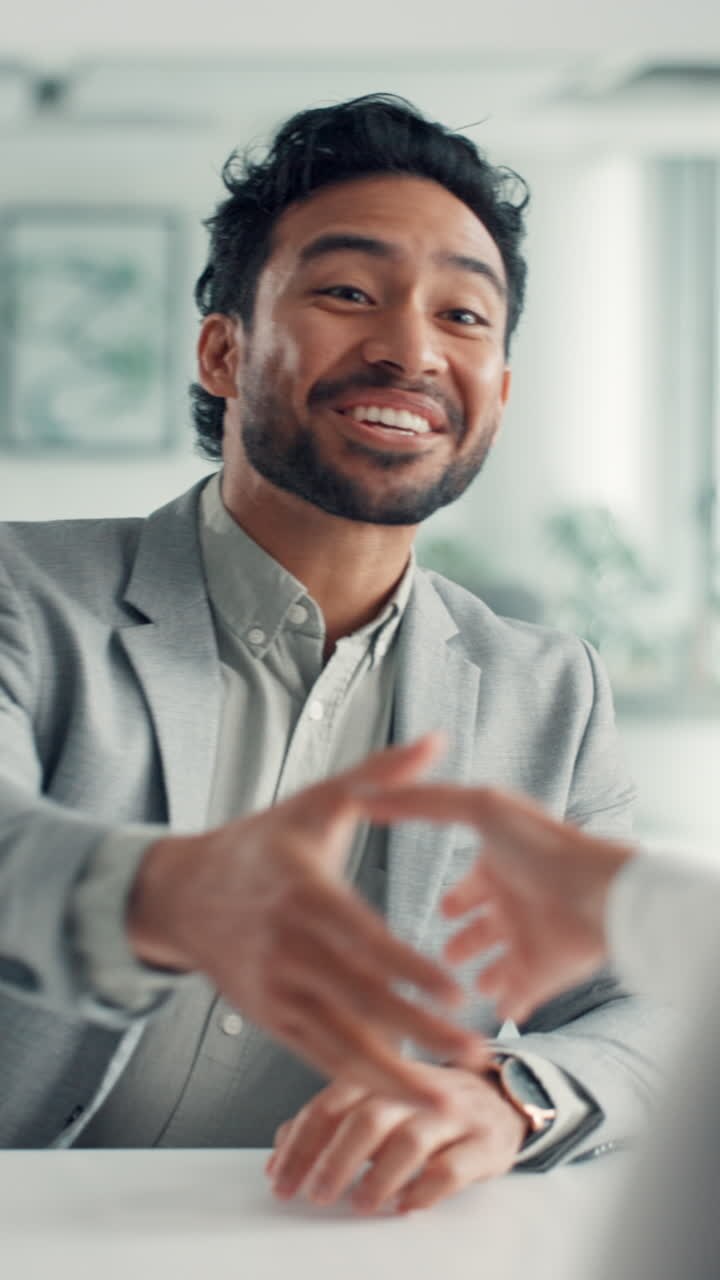 Happy Businessman Shaking Hands and Talking in an Office