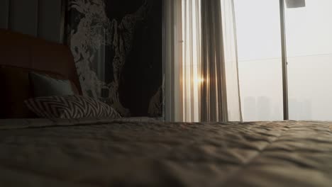 elegant bed linens of a luxury room hotel with sunlight through glass window