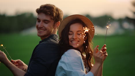 guy and girl posing with sparklers