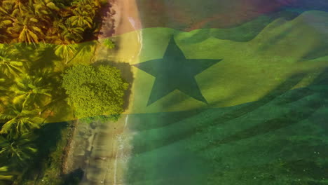 digital composition of waving ghana flag against aerial view of the beach and sea waves