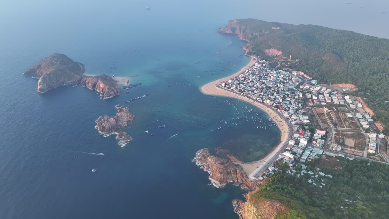 Stunning Aerial View of a Coastal Town and Bay with Boats