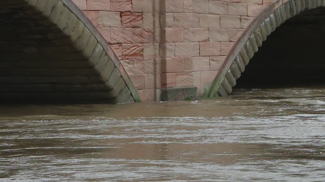 The River Severn in flood, flowing around the bridge at Bewdley