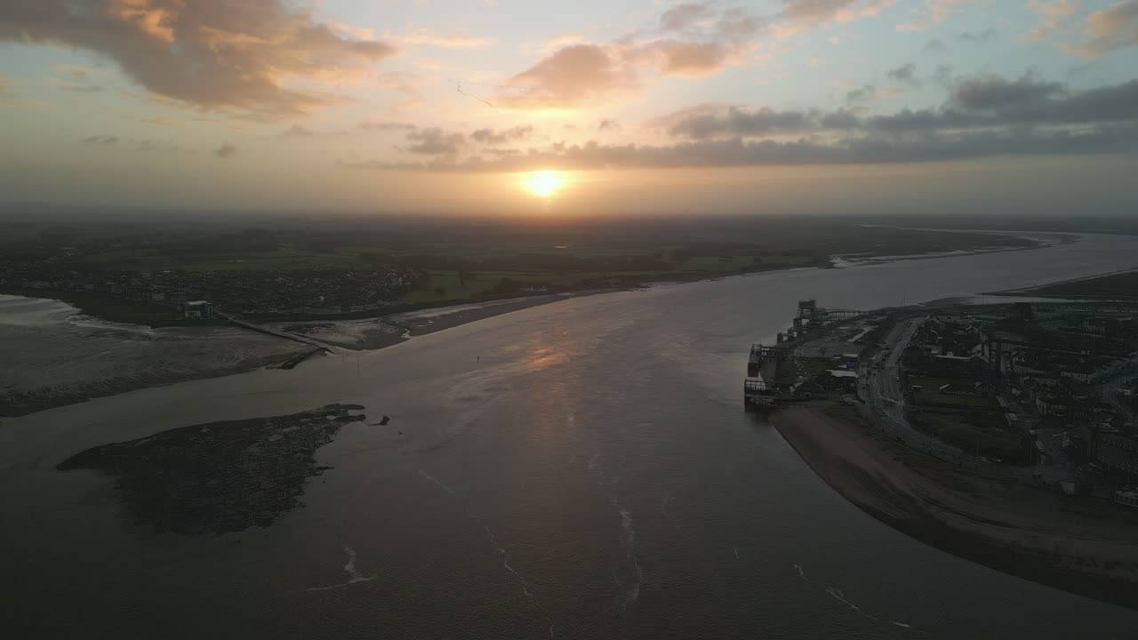 안개가 자욱한 수평선과 도시의 세부 사항이 있는 강 입 일출 접근법