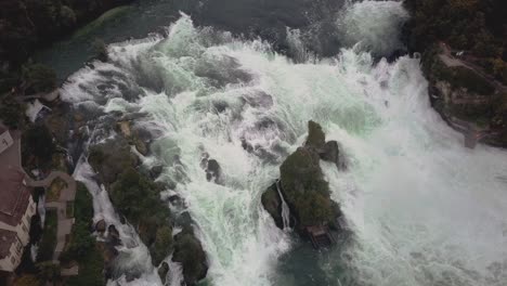 drone shot fly over with camera tilted down over large waterfall rheinfall in switzerland in 4k