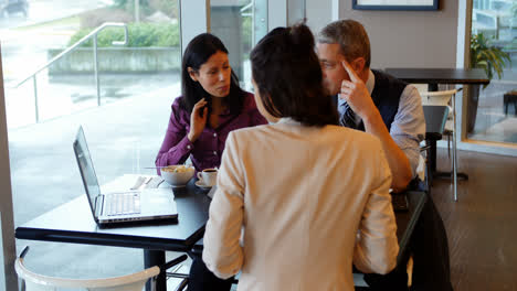 executives discussing over laptop