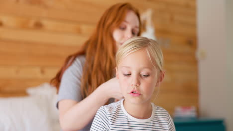 morning, mother and brushing hair of a child