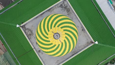 top-down view of a mosque dome with green and yellow spiral pattern