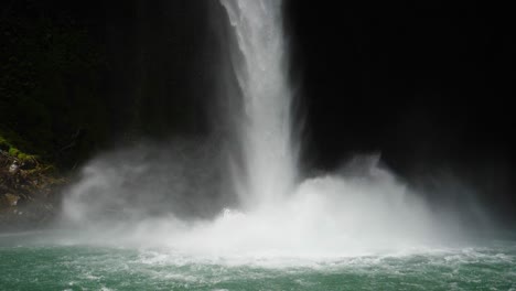 full shot, scenic view water pouring down on lake la fortuna in costa rica