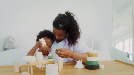 mother and child playing with wooden toys