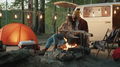 loving couple bonding and speaking at campsite