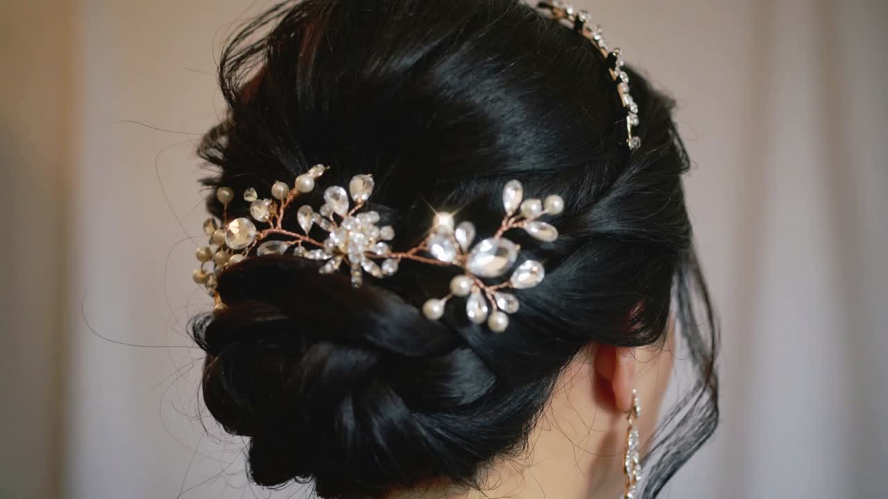 Tightening camera showing adult woman keeping head steady at studio, highlighting jeweled hairpiece