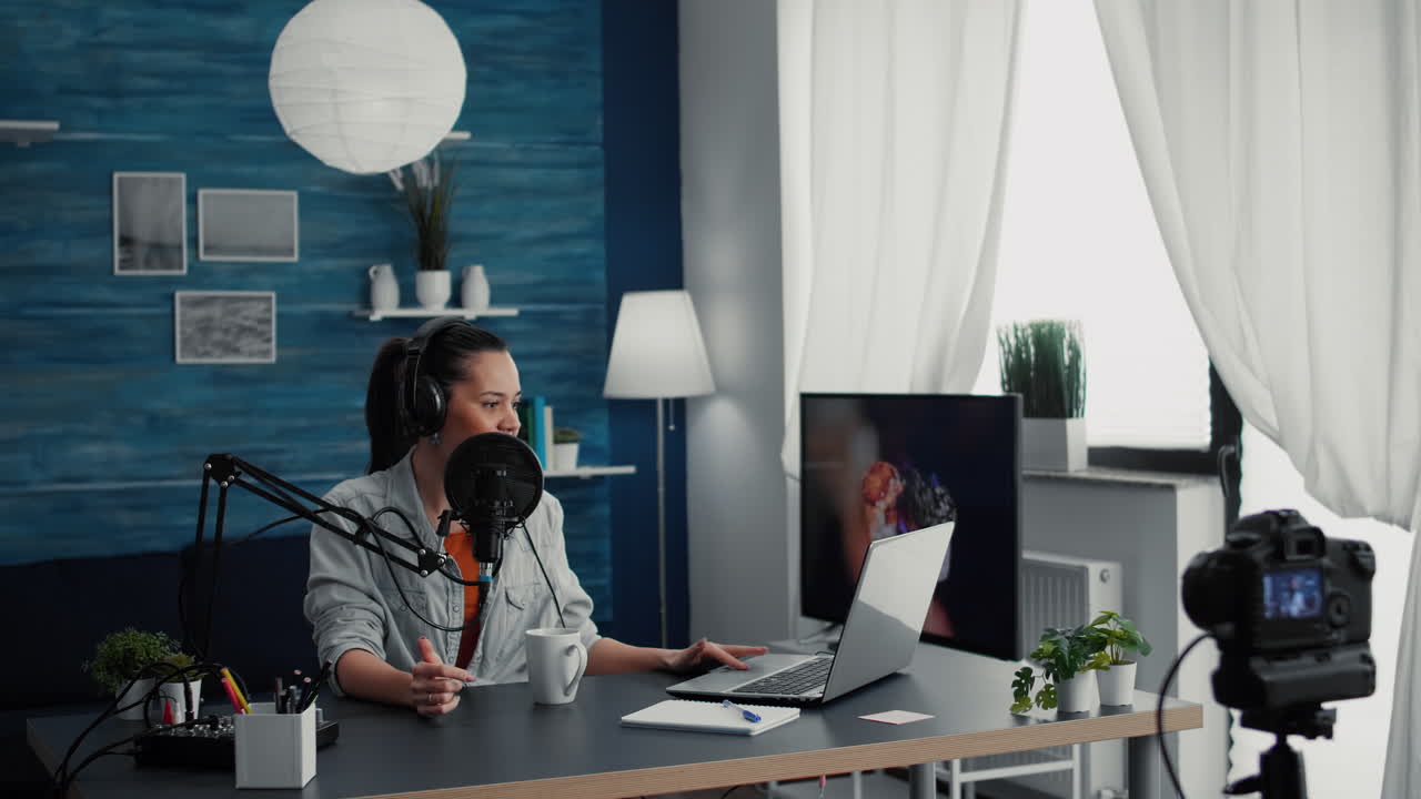 Famous internet podcaster checking show subject list on laptop while speaking to audience
