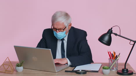 Sad-unhappy-senior-office-businessman-putting-on-face-medical-mask-to-prevent-respiratory-infection