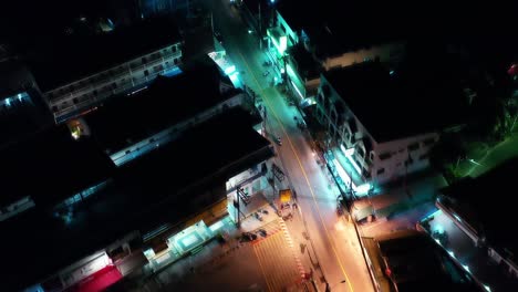 top view of the nigh city. night road of asian megapolis aerial view. scooter traffic.aerial.flying above. traveling on busy lit at nigh. thailand patong