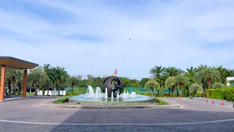 fountain with palm trees in bangkok, thailand