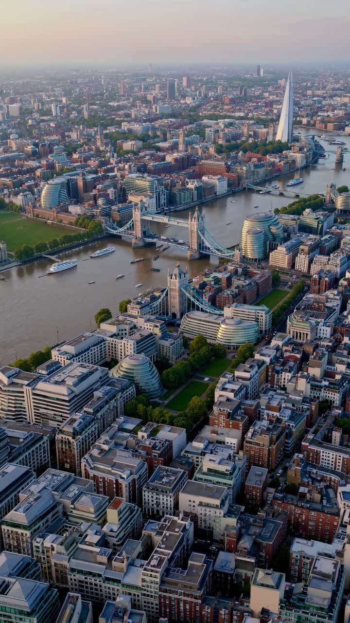 Aerial view video of a cityscape featuring a river, iconic bridges, and modern skyscrapers