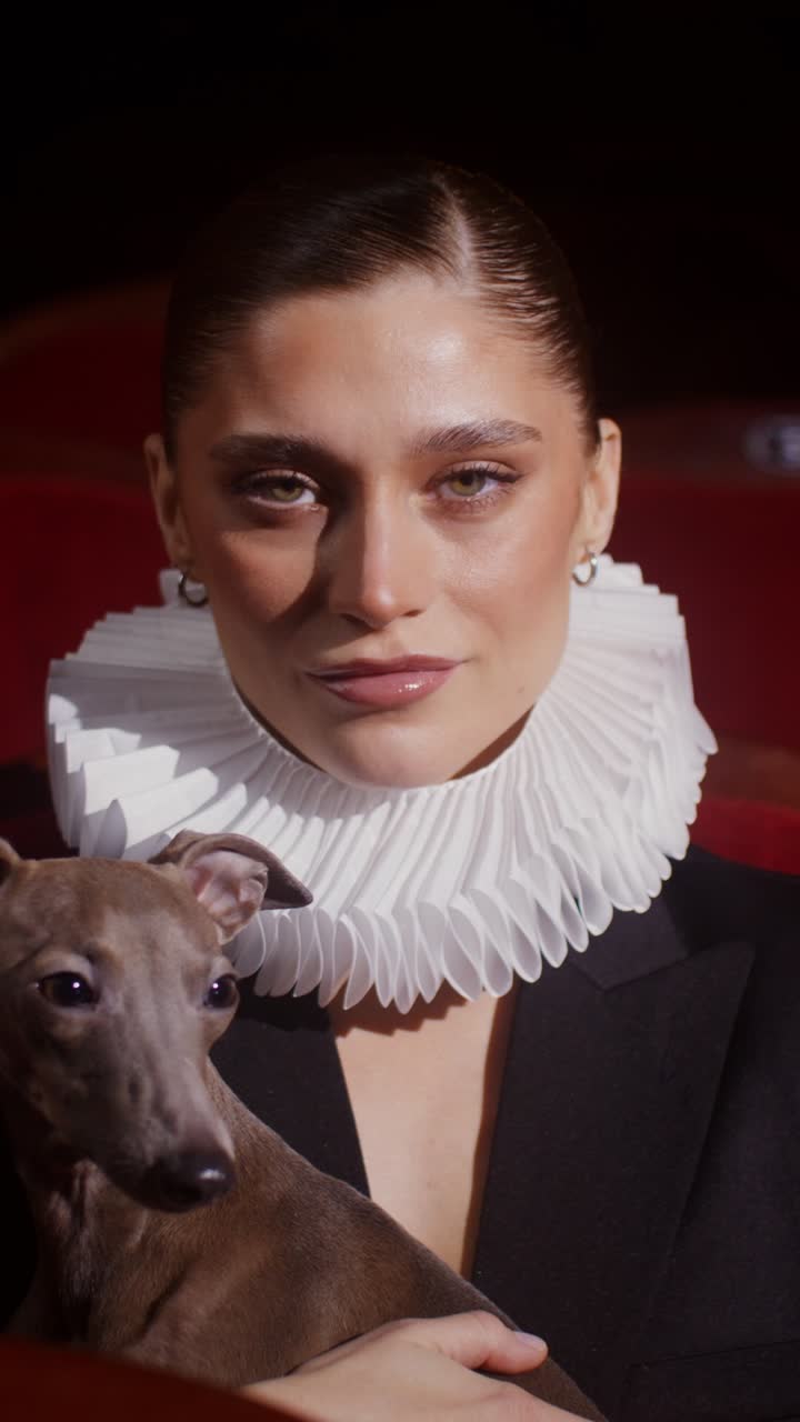 Woman with Italian Greyhound in Theater