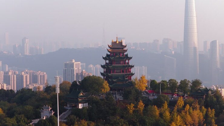 Imposing Hong'en Pavilion Against Foggy Cityscape In China, Chongqing Shi, Jiangbei. Aerial Rotate Shot