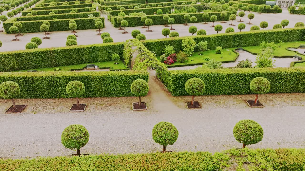 Aerial travel shot, symmetrical green tunnels at Rundāle baroque gardens Latvia