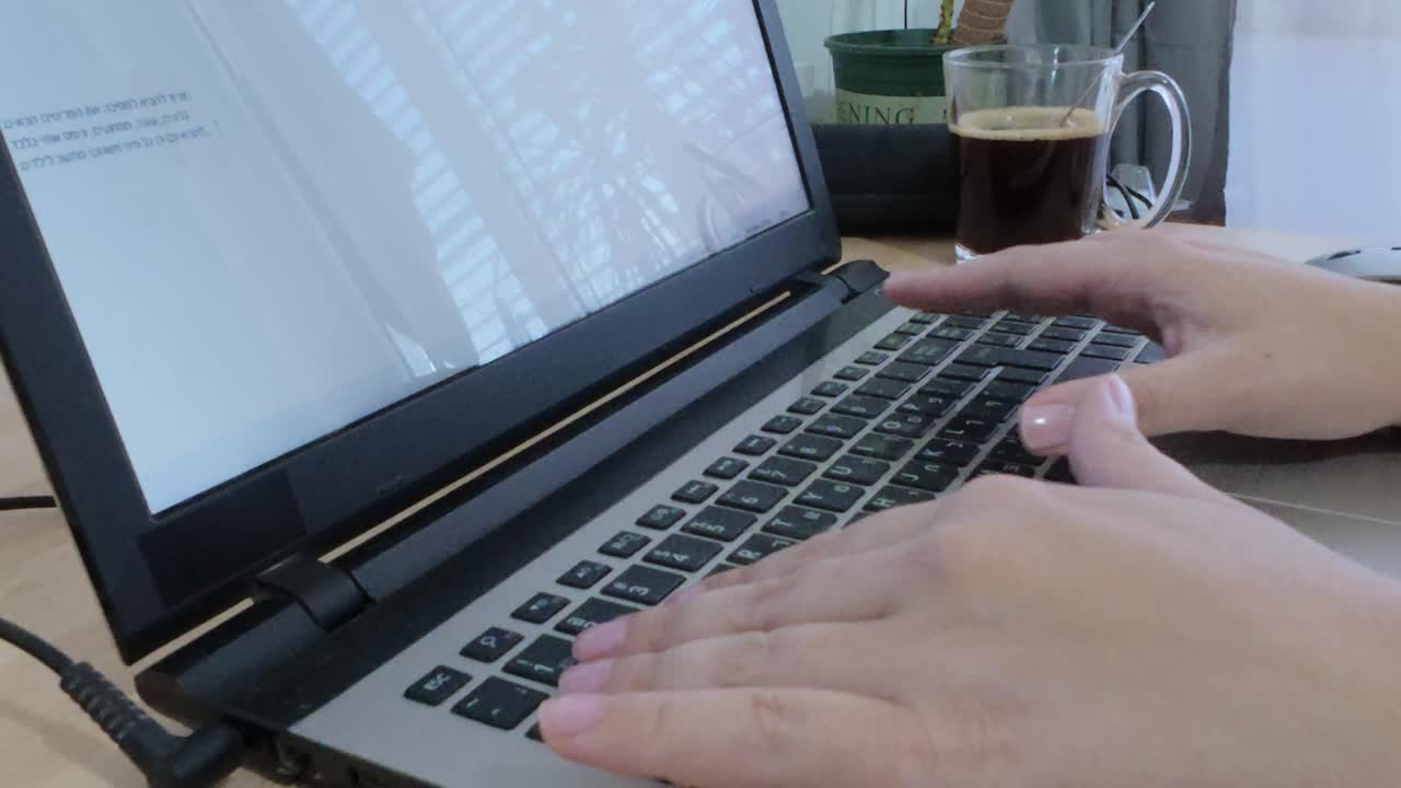 Freelancer's hands typing on a laptop, essential tools for independent work.