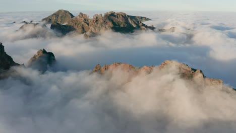 wild mountains of madeira covered by clouds, crazy weather pattern, aerial