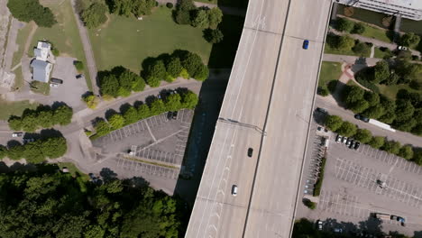 top-down aerial view of a tree-lined parking lot and nearby highway in chattanooga, tennessee