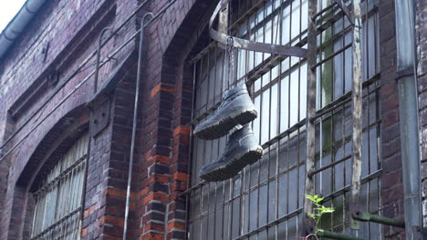 Shoes-hanging-on-the-laces-at-the-end-of-the-ladder