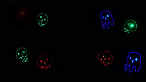 cartoony red and green skulls and blue ghosts light painting animation in 4k halloween background with space to add custom text
