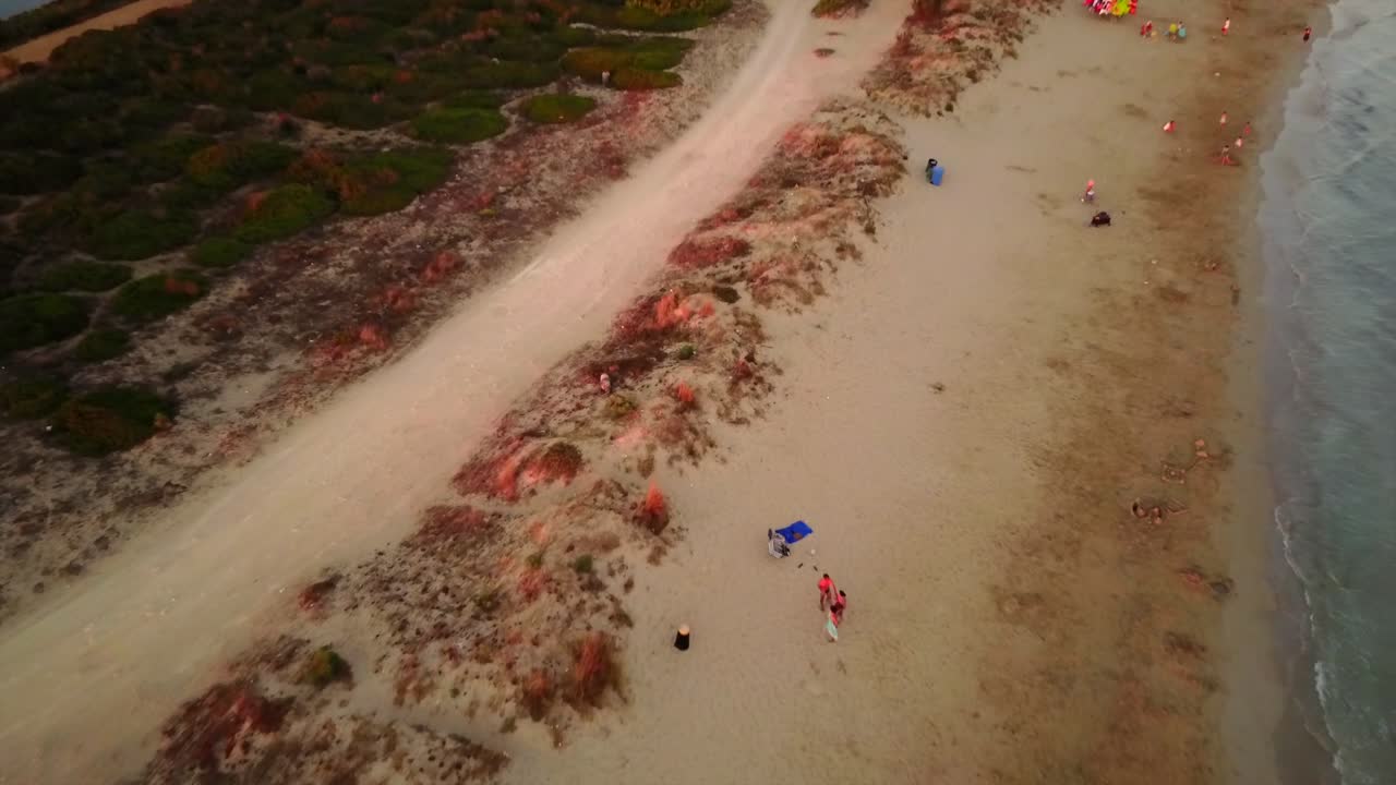 un dron vuela a lo largo de una playa de arena en puglia, sur de italia