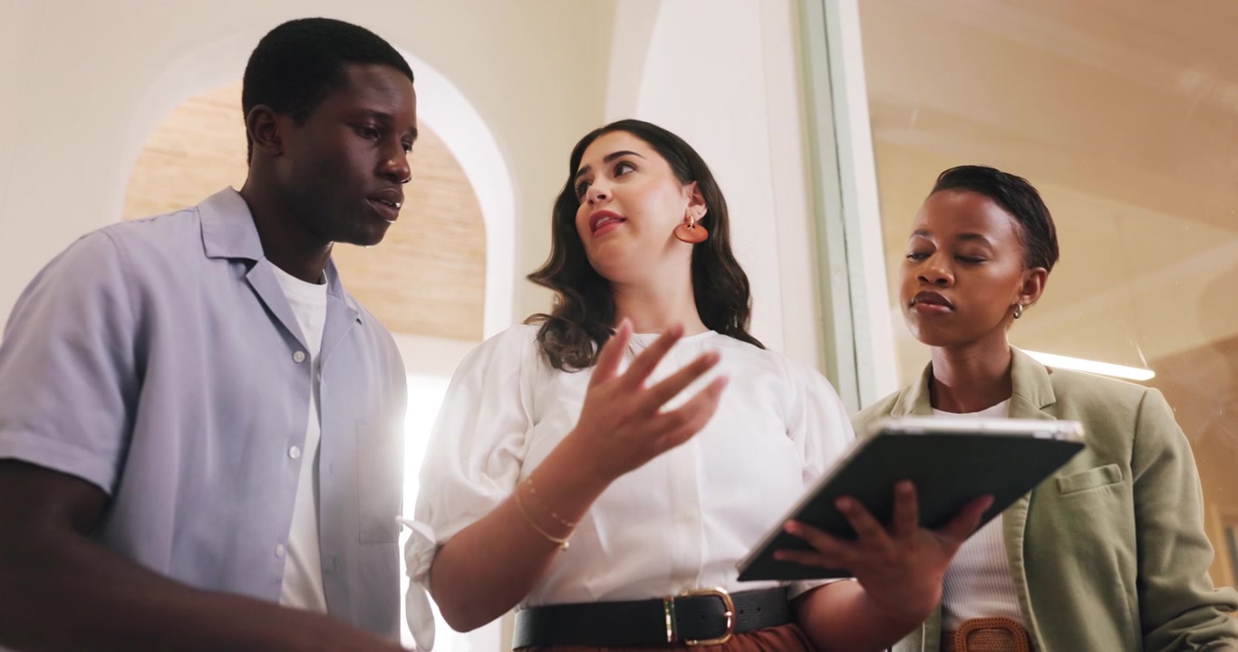 Diverse Business Team Discussing Project on Tablet in Office