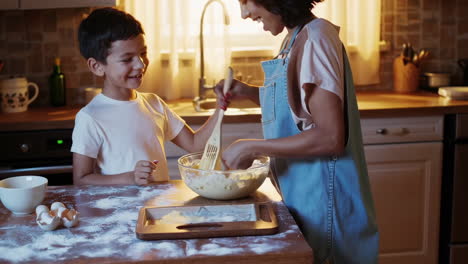 mother and son baking together in the kitchen