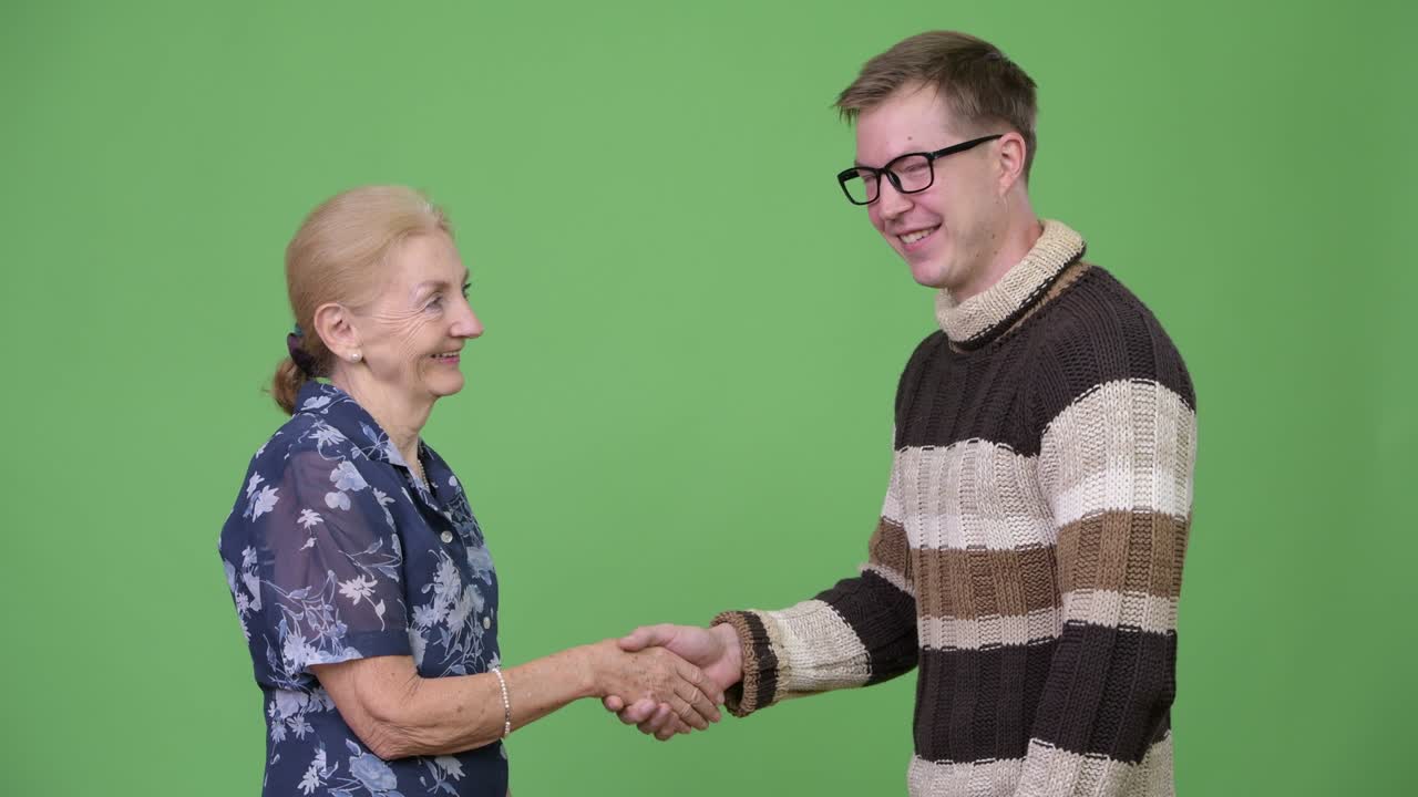 Happy grandmother and grandson shaking hands together