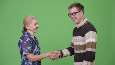 happy grandmother and grandson shaking hands together